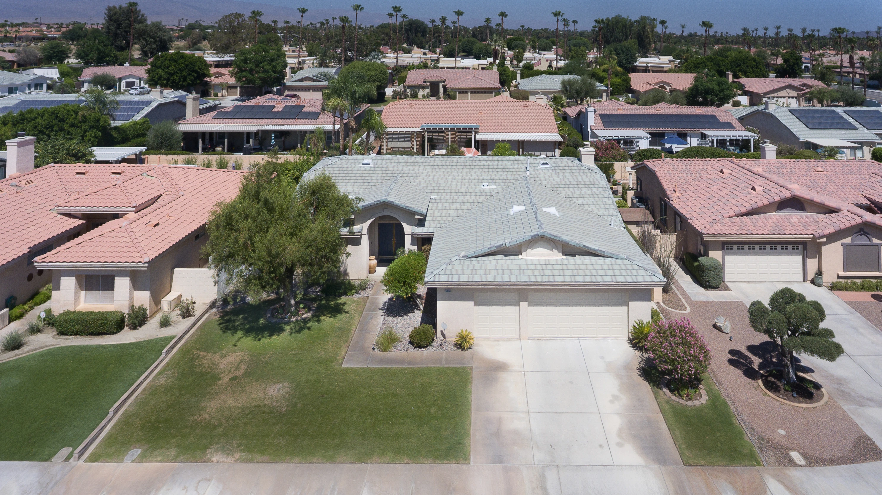 Aerial front elevation of a single-story tile-roof home in a desert community